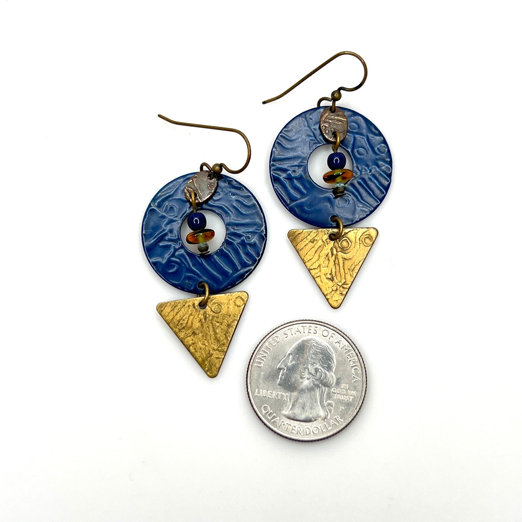 Vintage mixed-media earrings with embossed blue enamel and brass accents with quarter for scale