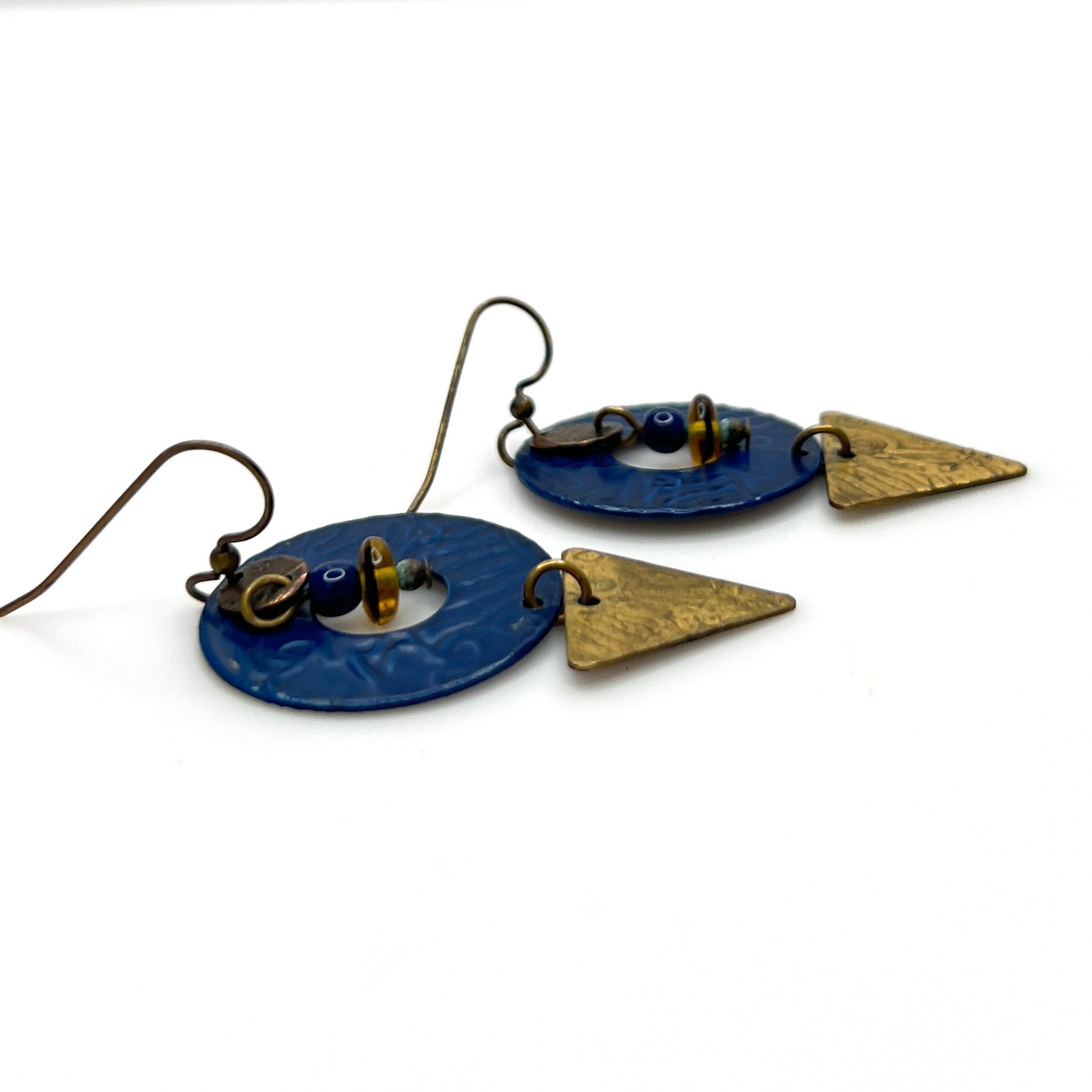 Side view of vintage geometric brass and enamel dangle earrings
