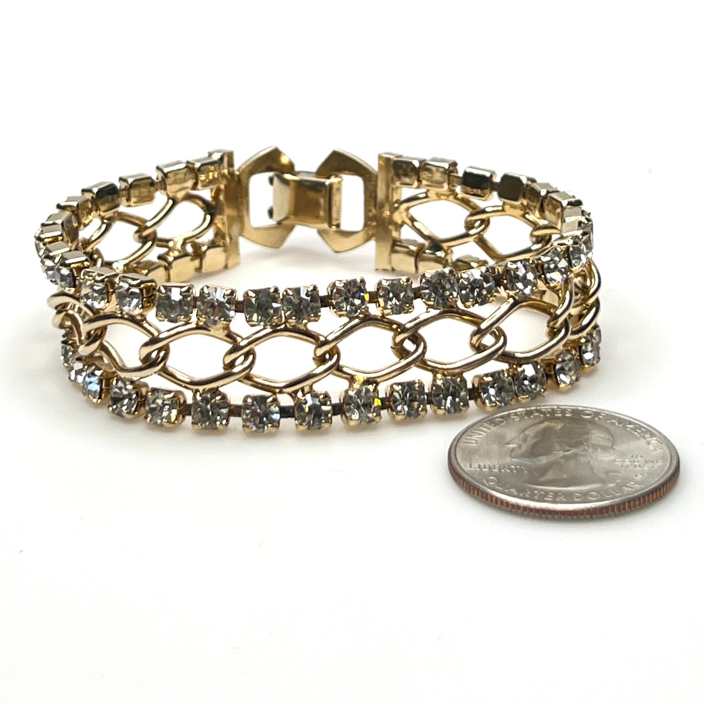 Vintage gold tone rhinestone bracelet with double-row crystal design with quarter for scale