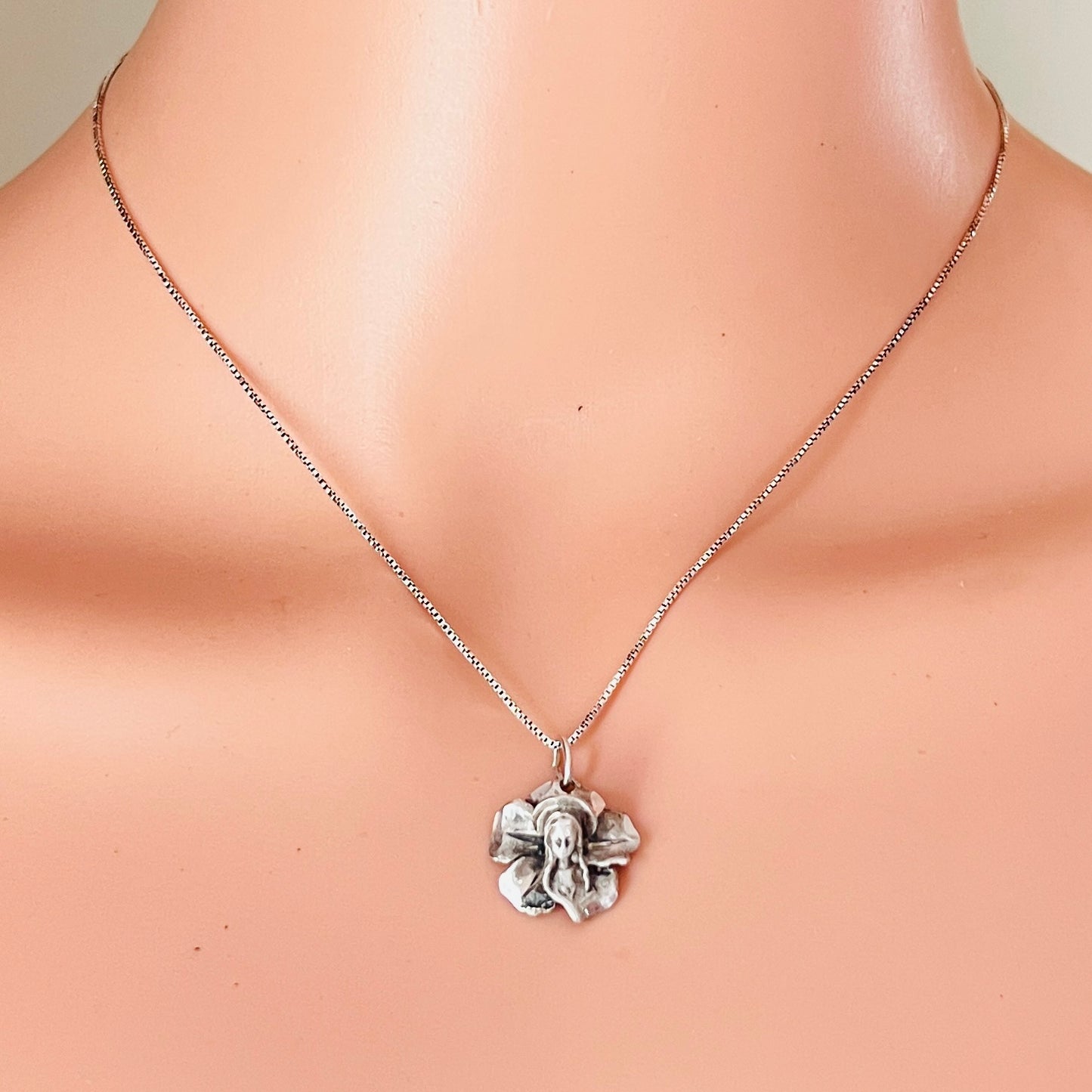 Vintage sterling silver Madonna flower pendant necklace worn on mannequin