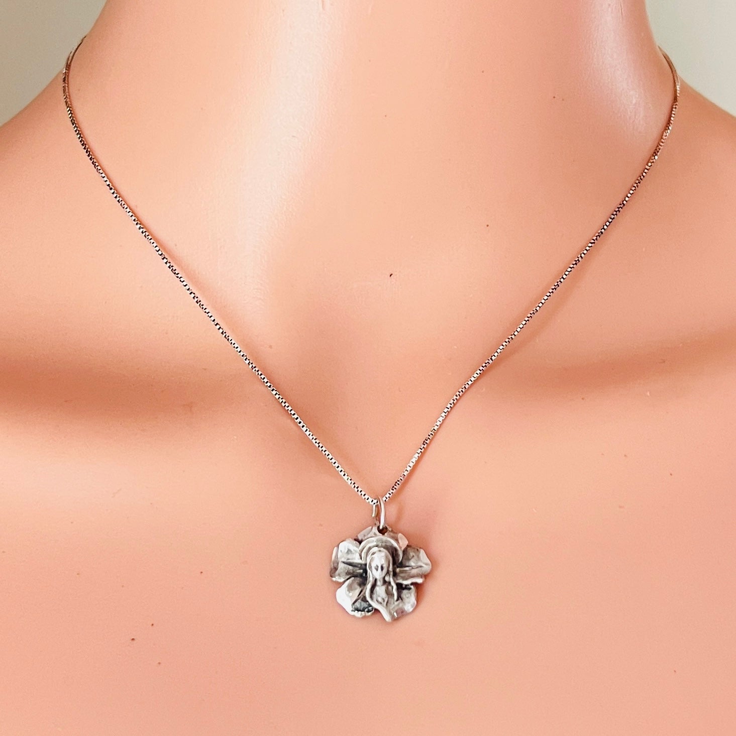 Vintage sterling silver Madonna flower pendant necklace worn on mannequin