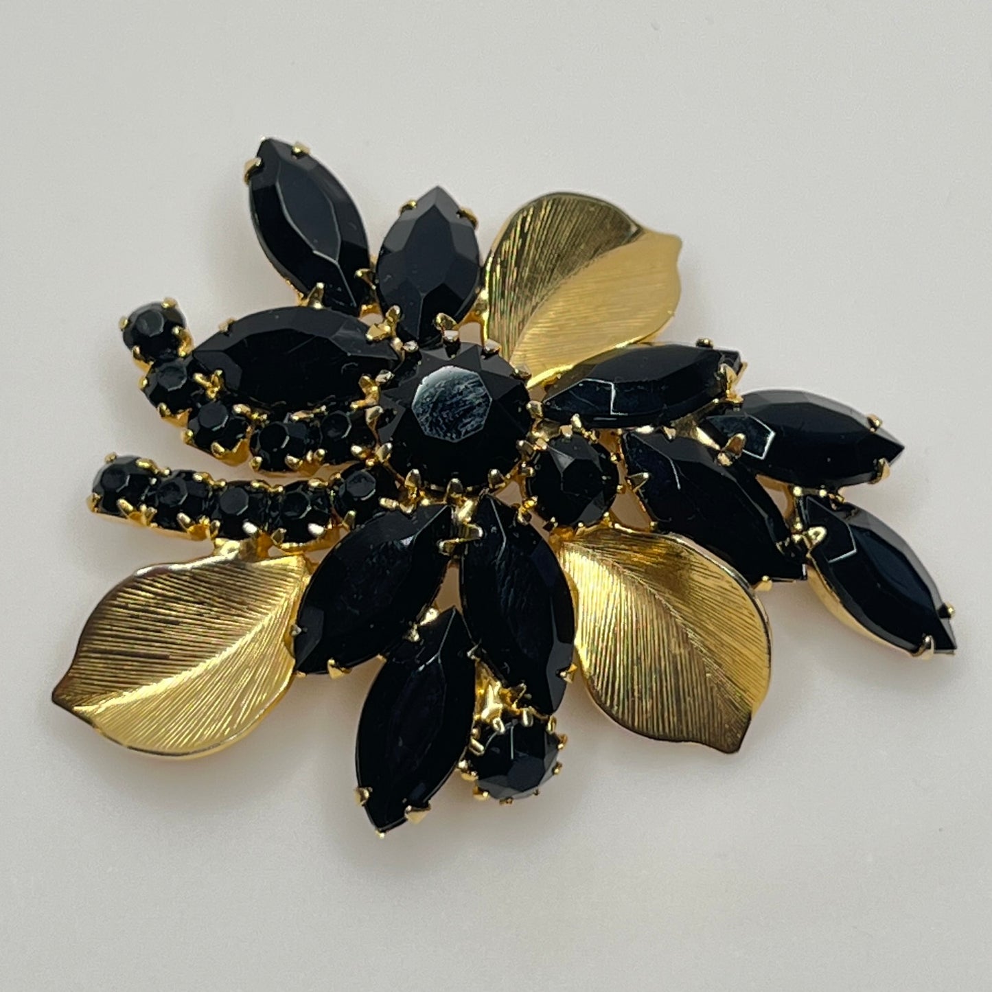 1950s vintage jewelry set with prong-set black stones and sculpted floral design