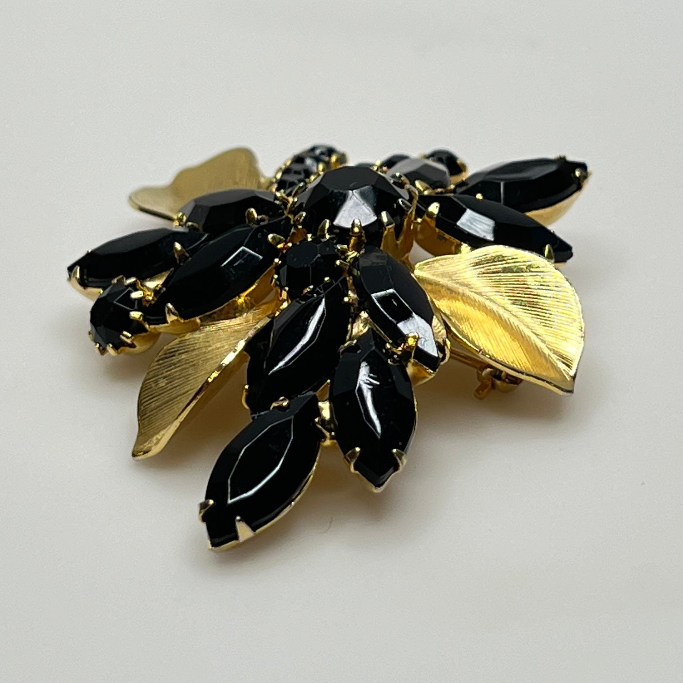 1950s vintage jewelry set with prong-set black stones and sculpted floral design