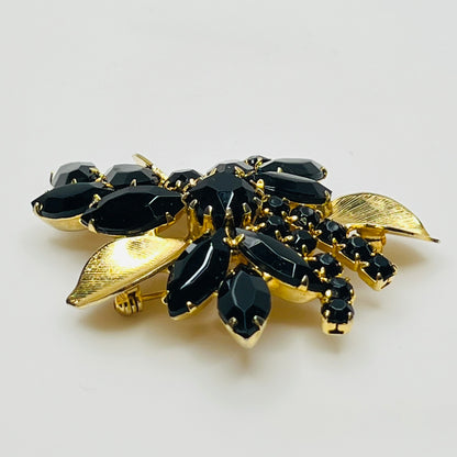 1950s vintage jewelry set with prong-set black stones and sculpted floral design