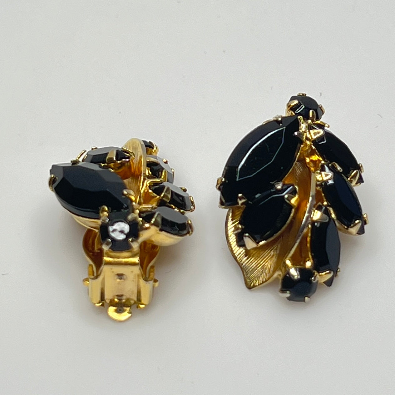 Vintage black rhinestone and gold-tone leaf brooch with matching clip-on earrings