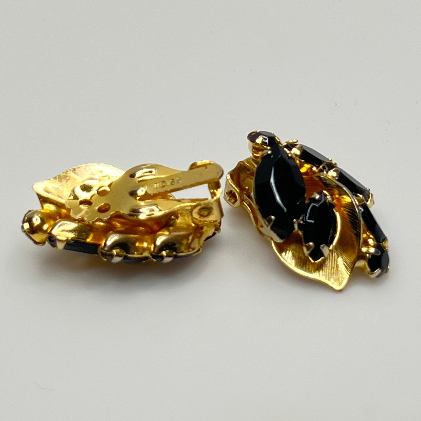 Vintage black rhinestone and gold-tone leaf brooch with matching clip-on earrings