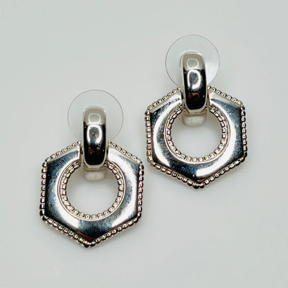 Close-up of earrings showing silver finish and 14K gold post with stabilizer backs