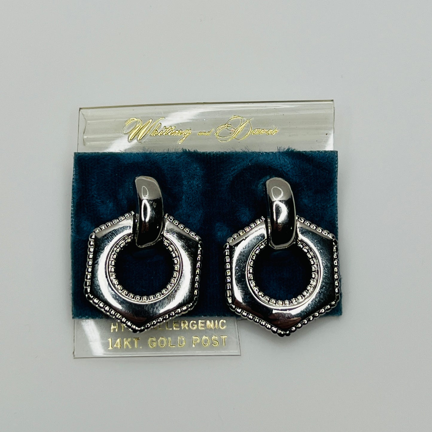 Pair of silver door knocker earrings on original Whiting & Davis card