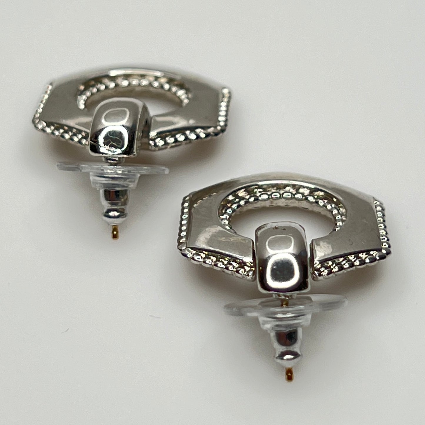Close-up of earrings showing silver finish and 14K gold post with stabilizer backs