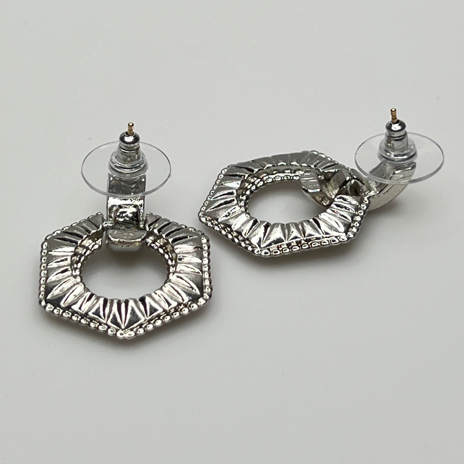 Close-up of earrings showing silver finish and 14K gold post with stabilizer backs
