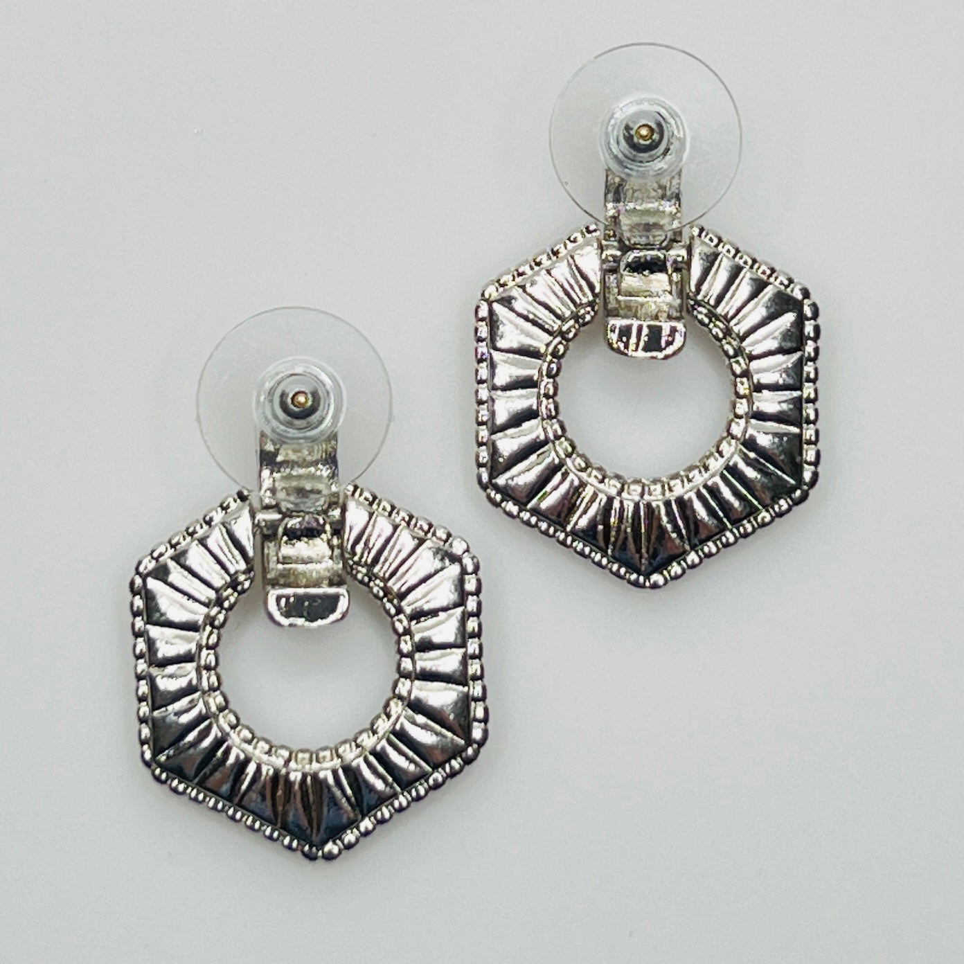 Close-up of earrings showing silver finish and 14K gold post with stabilizer backs