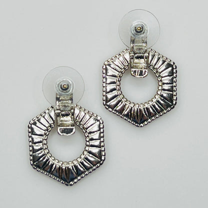 Close-up of earrings showing silver finish and 14K gold post with stabilizer backs