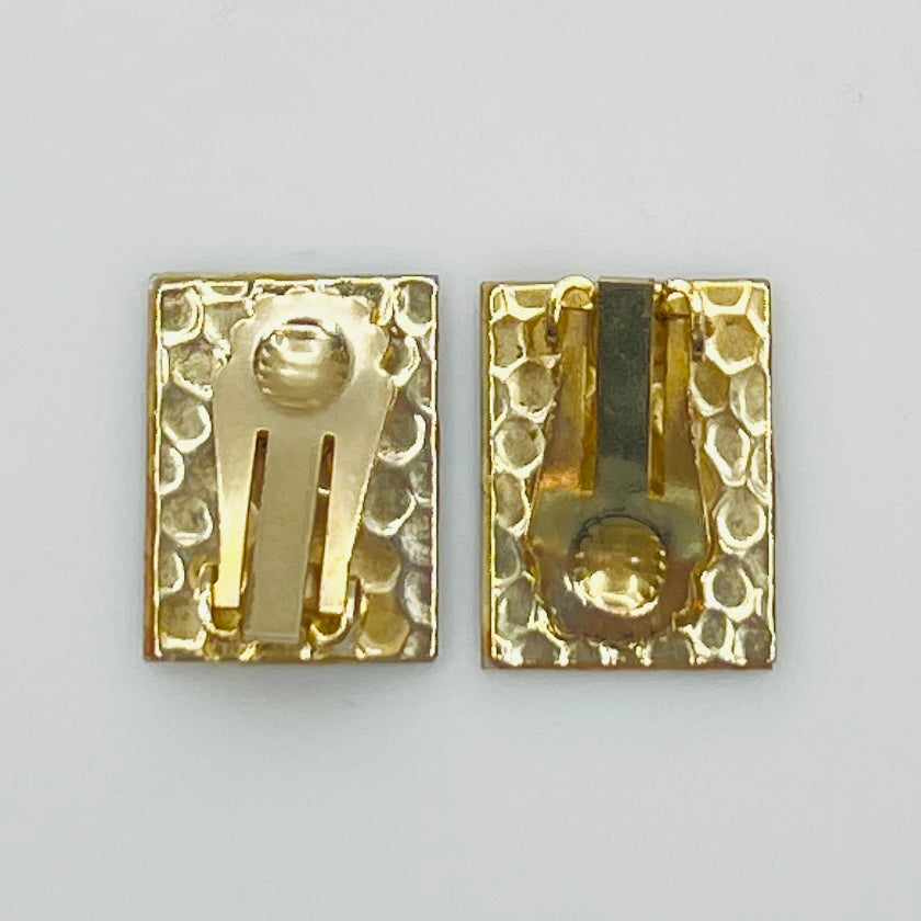 Back view of gold-tone clip-on earrings with textured finish