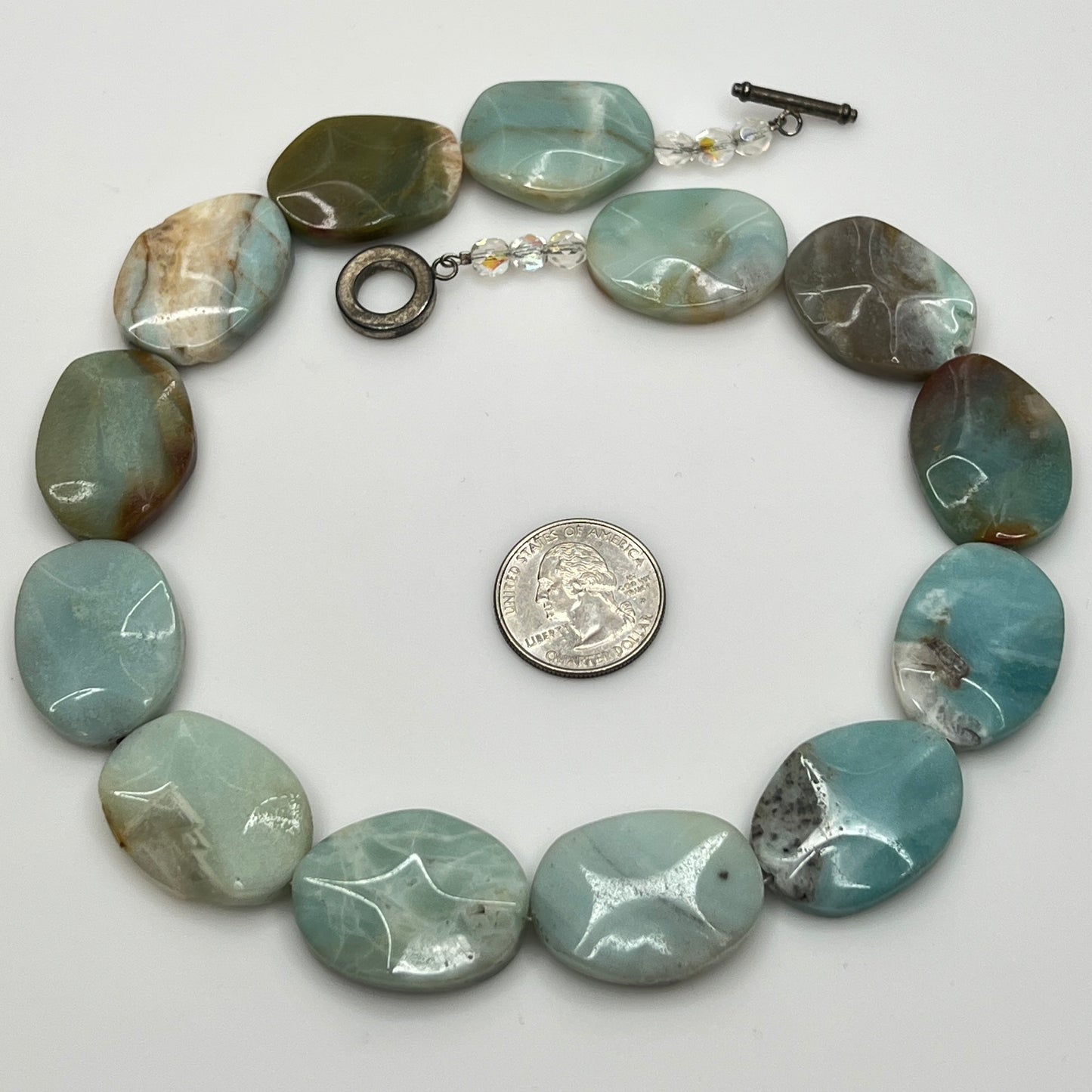 Close-up of pale blue-green amazonite beads with natural marbling