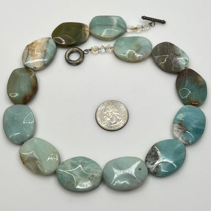 Close-up of pale blue-green amazonite beads with natural marbling