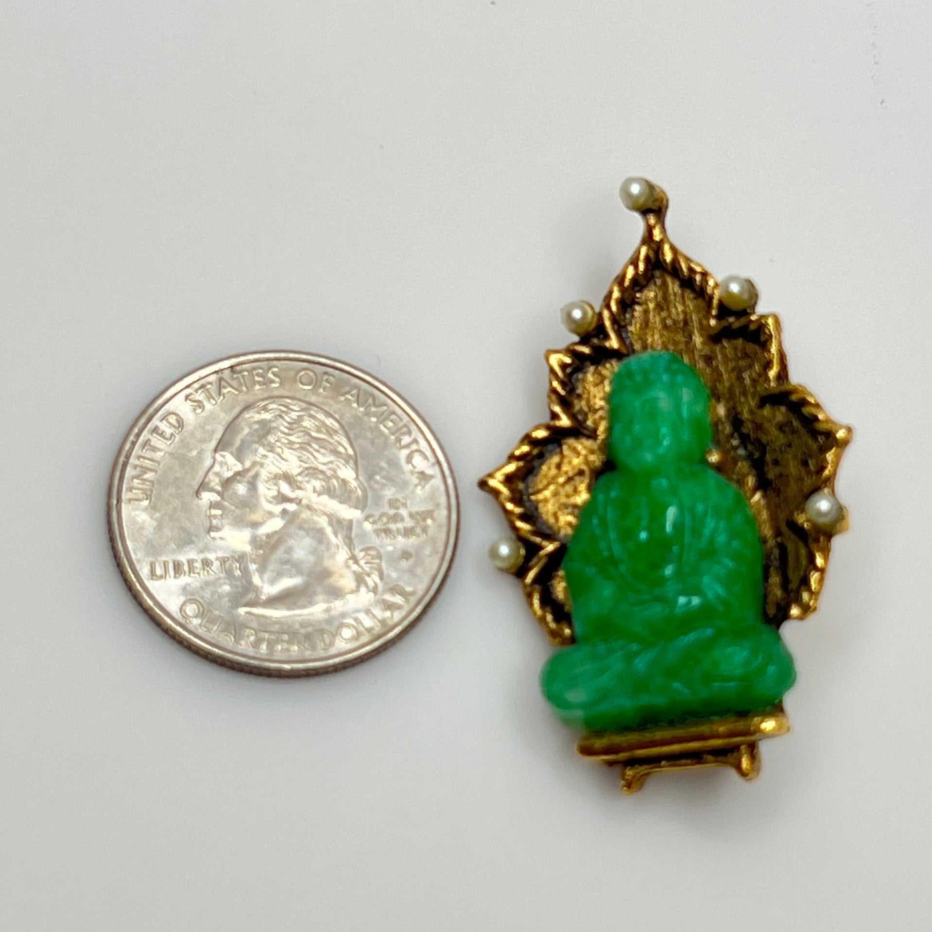 Signed Ambassador brooch featuring green glass Buddha and pearl accents