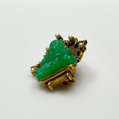 Signed Ambassador brooch featuring green glass Buddha and pearl accents