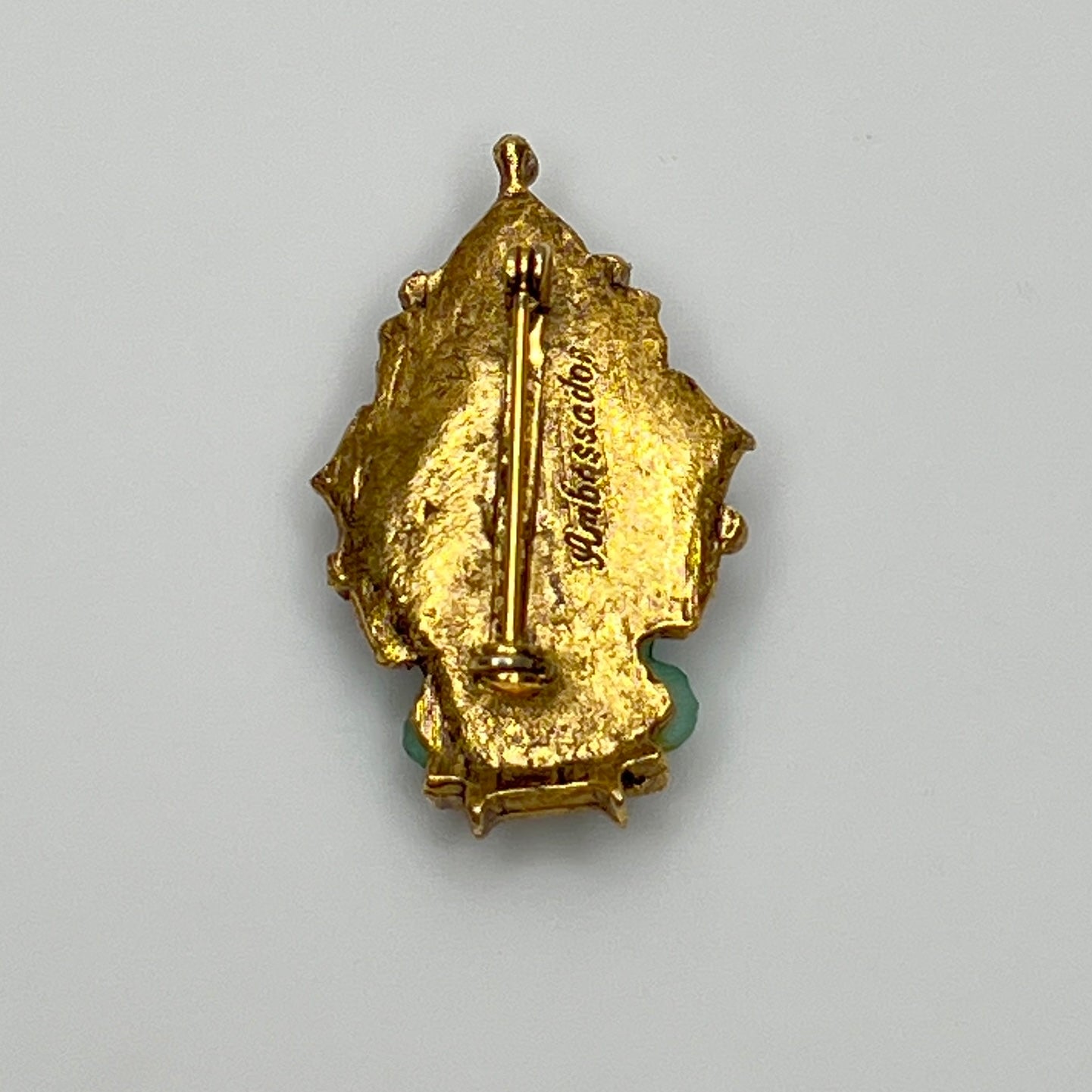 Mid-century gold-tone Buddha pin with lotus-style backdrop