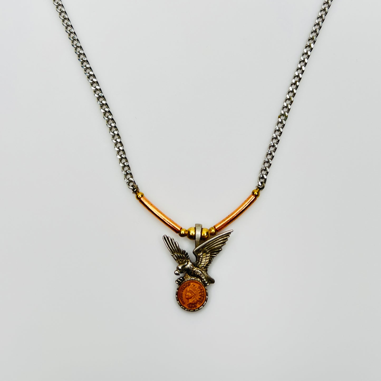 Mixed metal eagle pendant necklace with coin medallion detail