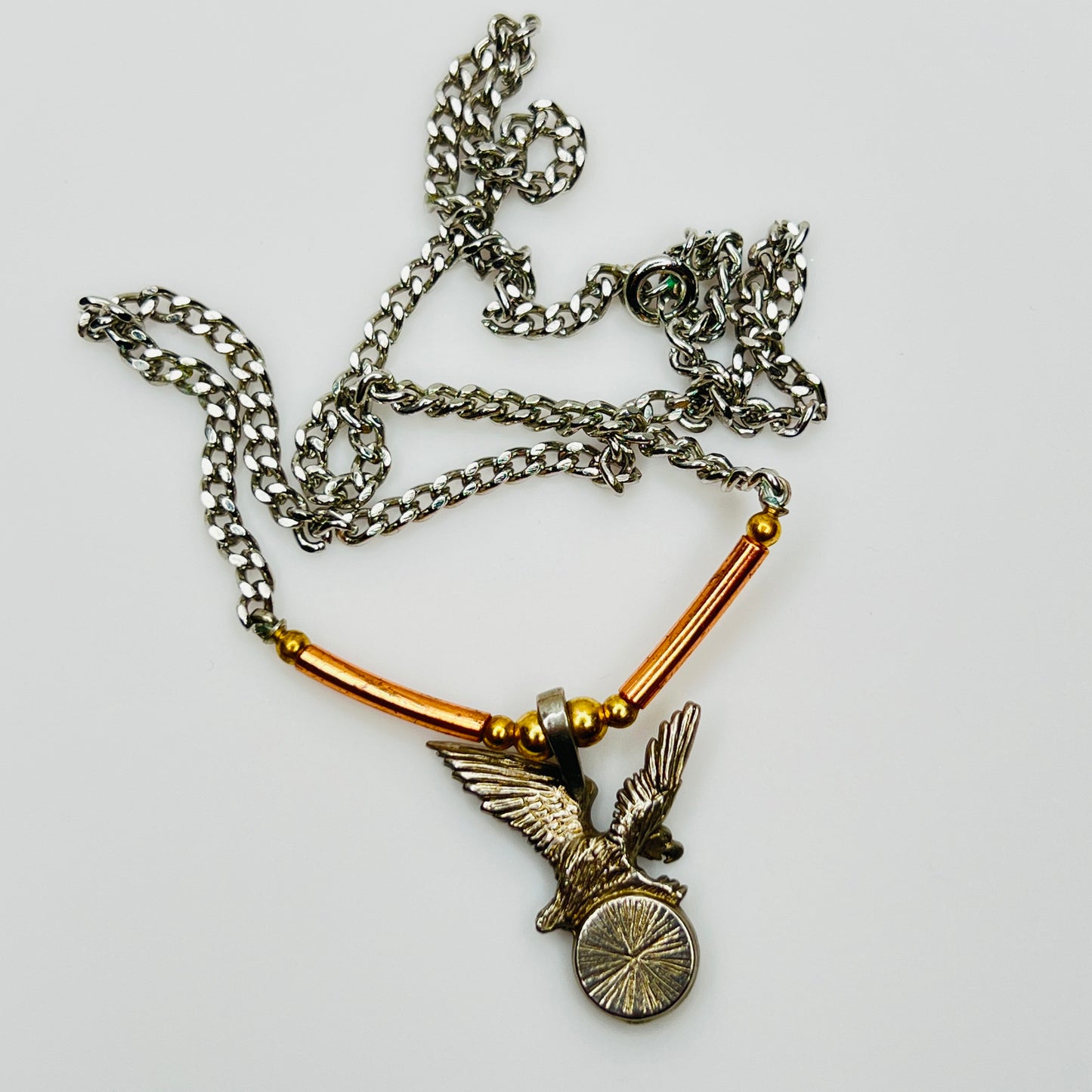 Back view of eagle pendant with copper tube accents on chain