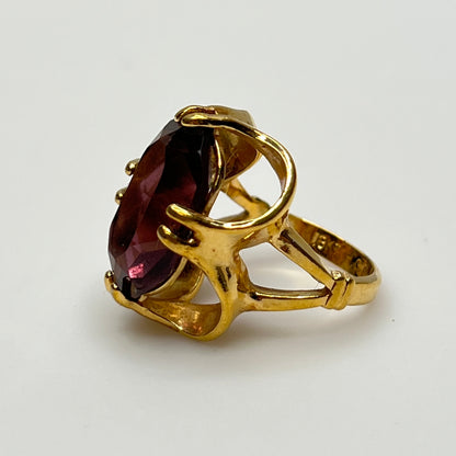 Purple crystal statement ring in yellow gold-tone floral setting