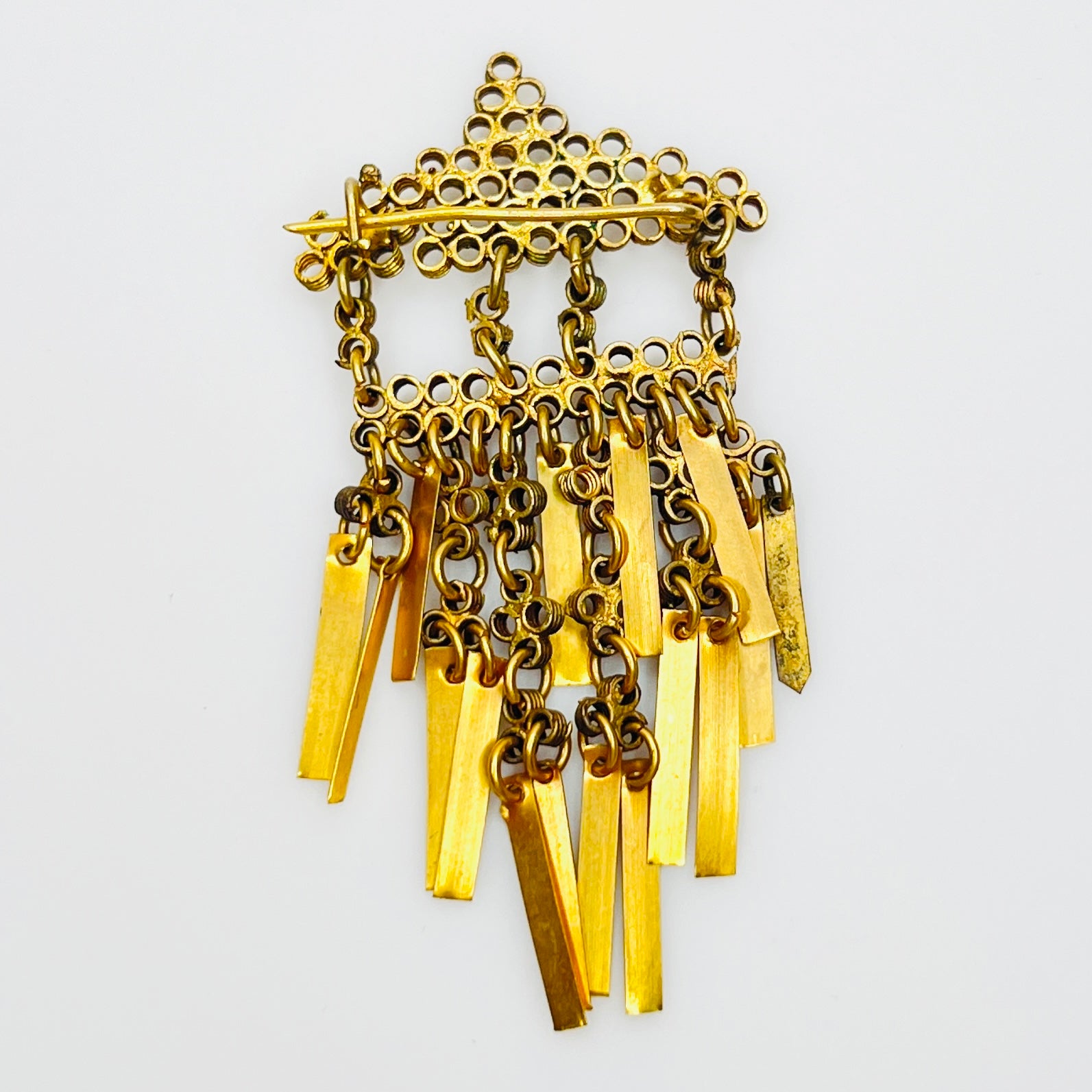 Reverse of antique Art Deco brass tassel brooch with C-clasp