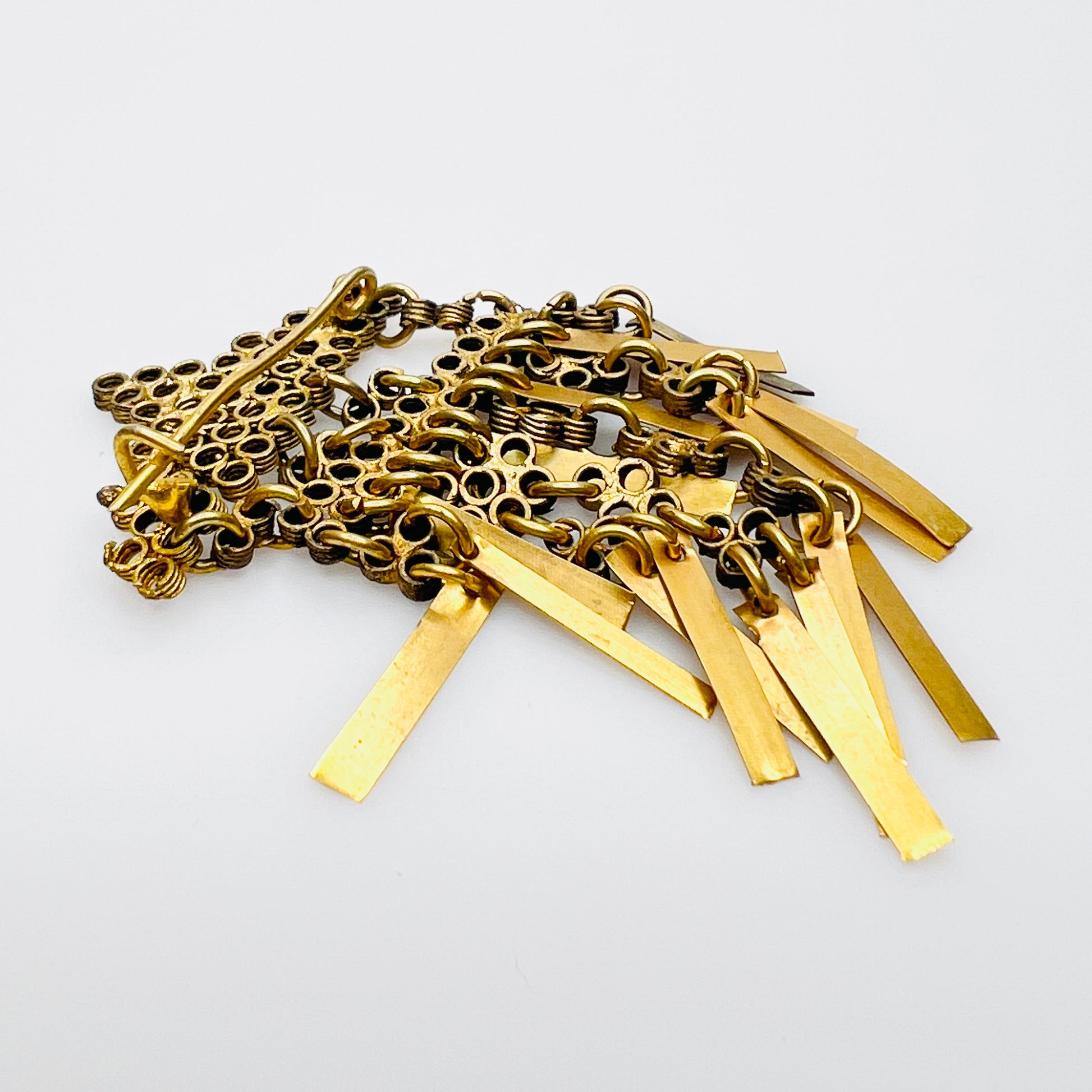 Back view of vintage brass geometric tassel brooch