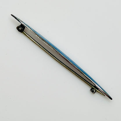 Side view of brooch showing silver base and clasp