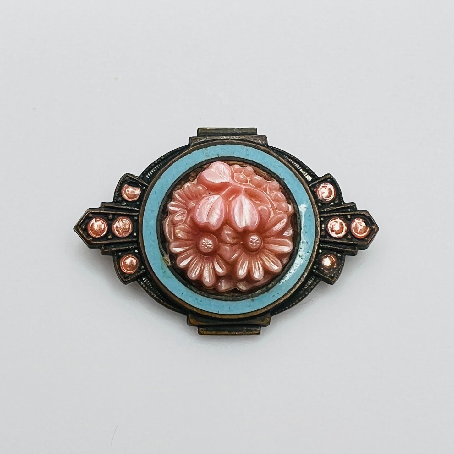 Victorian floral brooch with pink celluloid flowers and blue enamel frame