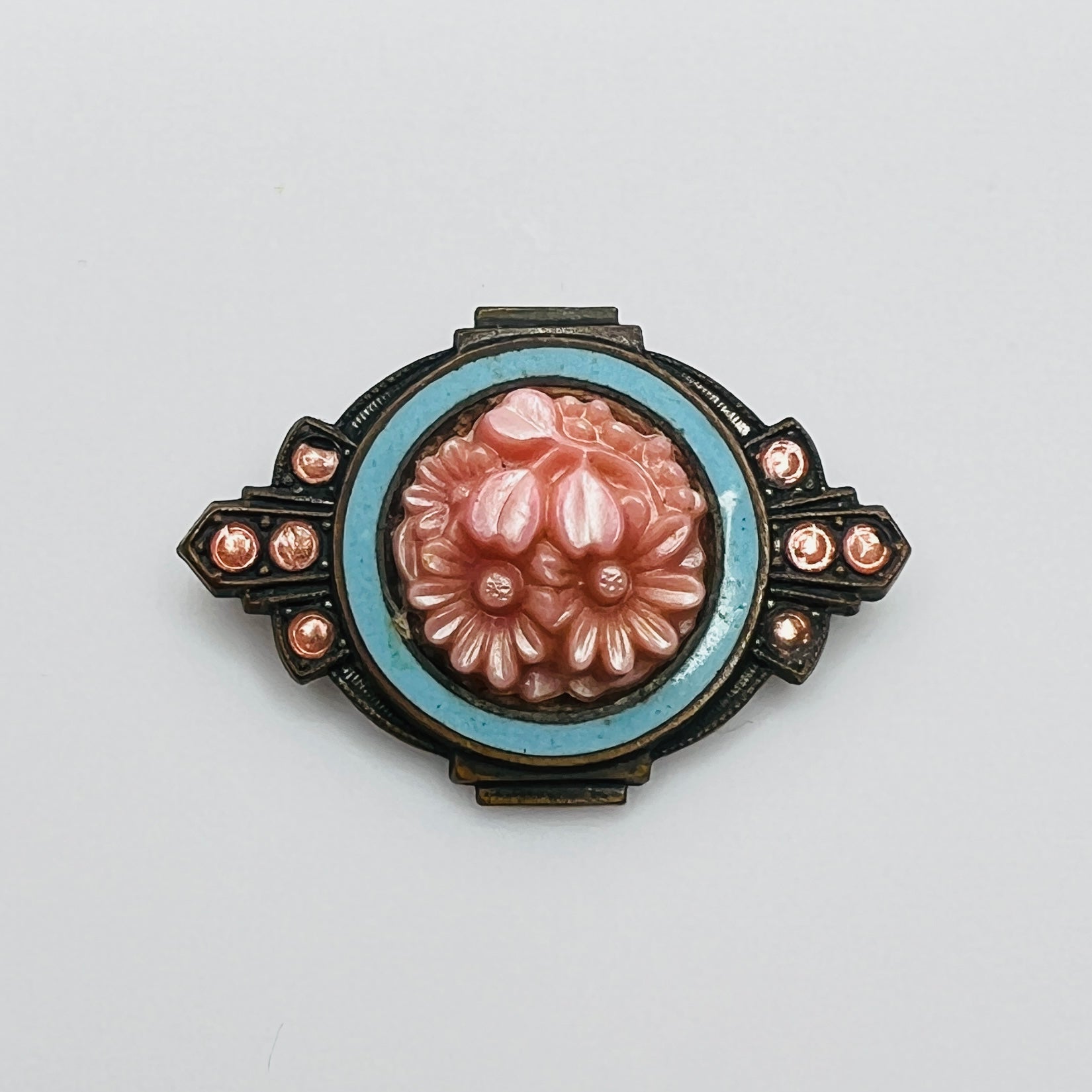 Victorian floral brooch with pink celluloid flowers and blue enamel frame