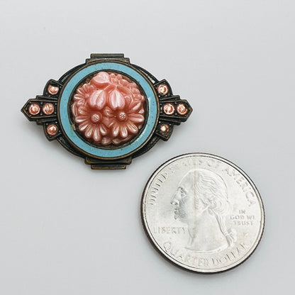 Antique pink celluloid floral brooch shown beside quarter for scale