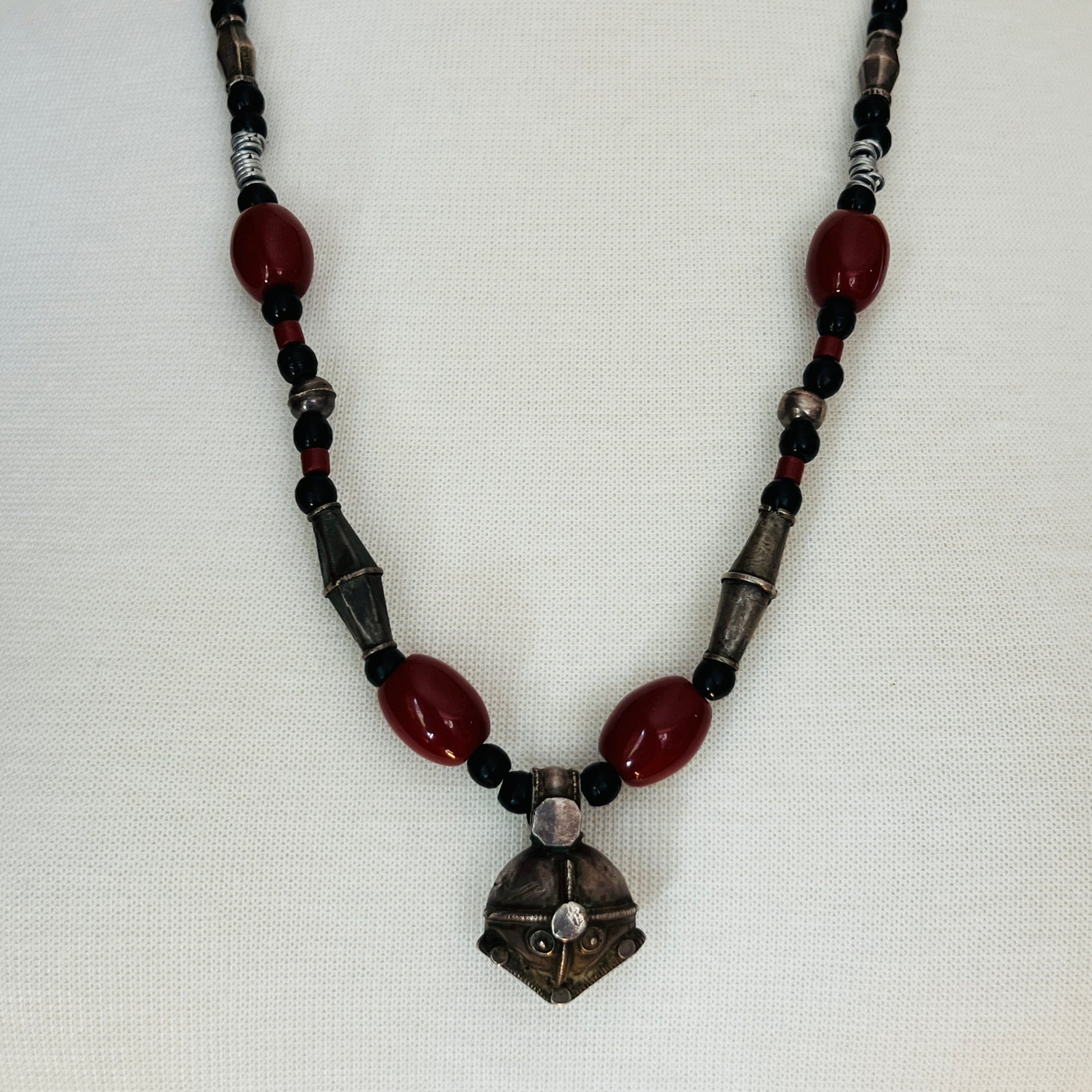 Vintage ethnic-inspired red ceramic and black glass bead necklace with matching earrings and silver-tone pendant