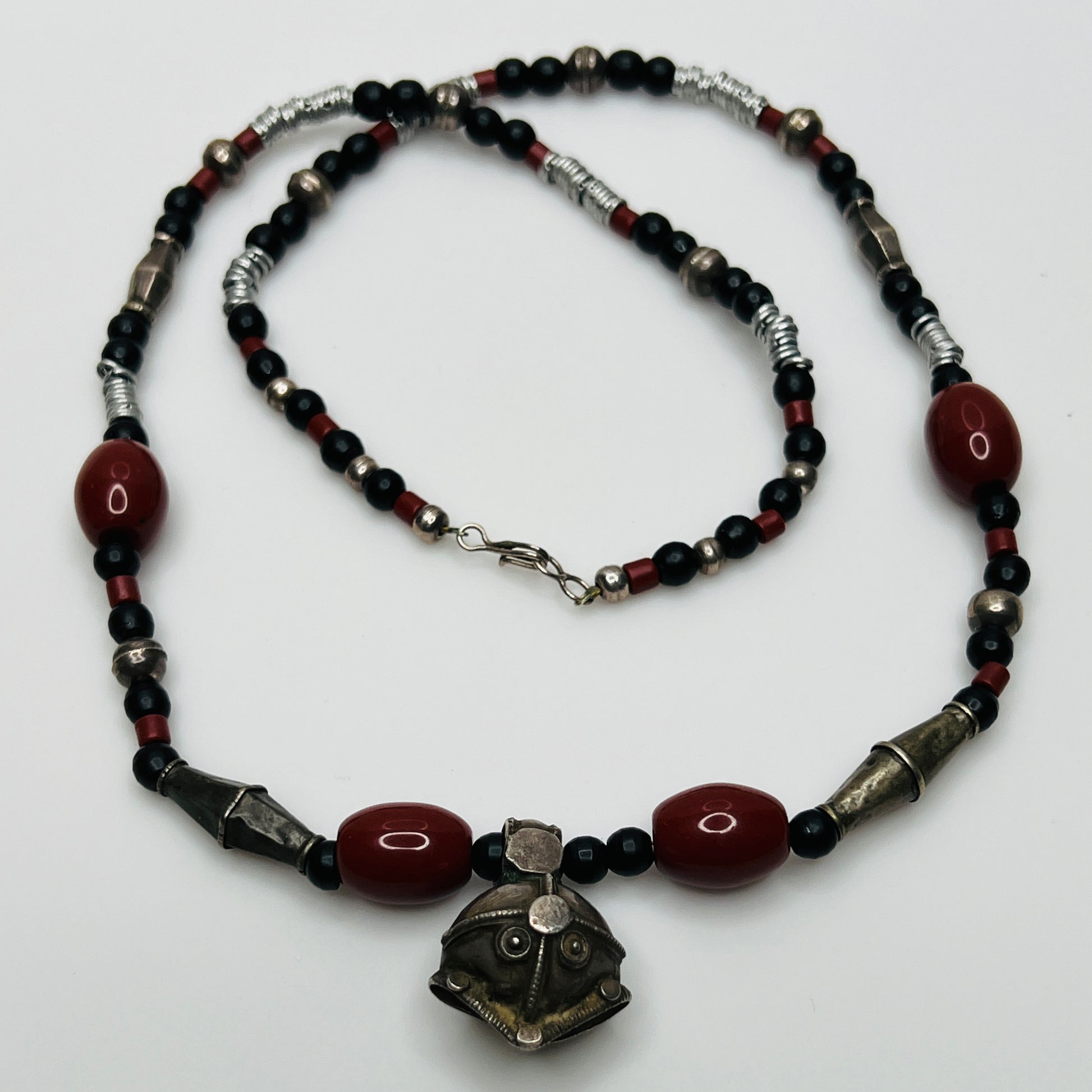 Vintage ethnic-inspired red ceramic and black glass bead necklace with matching earrings and silver-tone pendant