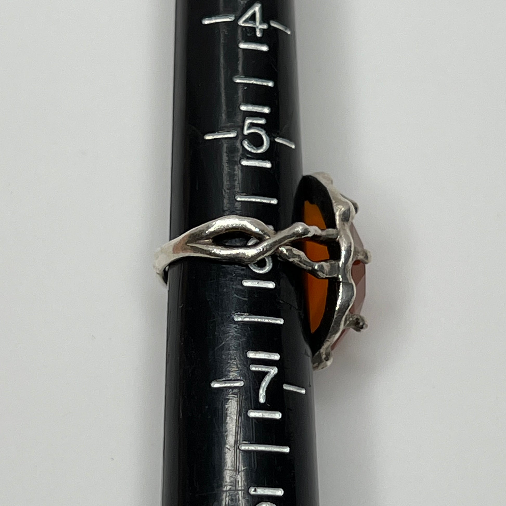 Vintage sterling silver ring with faceted oval orange carnelian in sculptural bezel setting