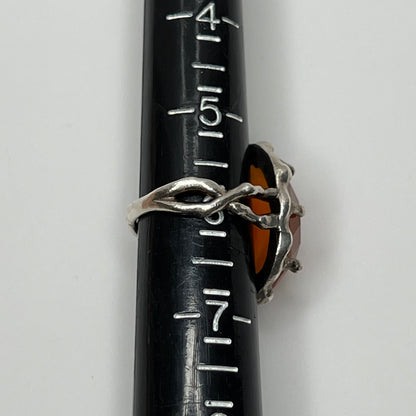 Vintage sterling silver ring with faceted oval orange carnelian in sculptural bezel setting
