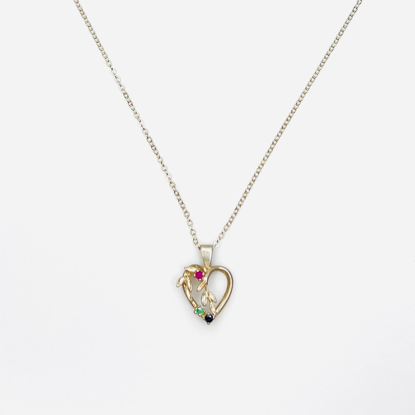 Vintage Avon sterling silver heart necklace with genuine ruby, emerald, and sapphire gemstones.