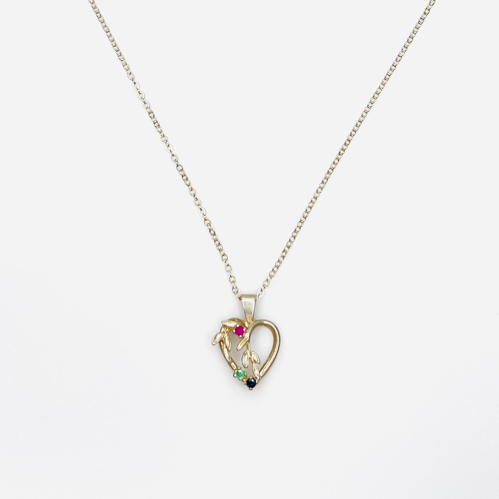 Vintage Avon sterling silver heart necklace with genuine ruby, emerald, and sapphire gemstones.