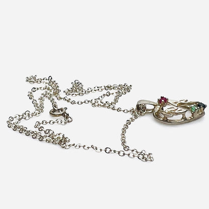 Side view of Avon sterling heart necklace with genuine ruby, emerald, and sapphire accents.