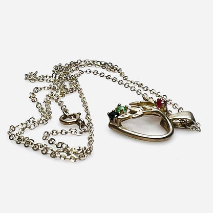 Side view of Avon sterling heart necklace with genuine ruby, emerald, and sapphire accents.