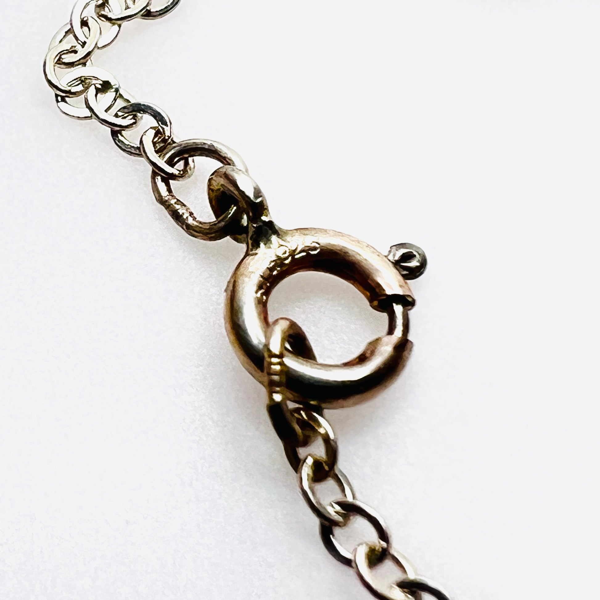 Close-up of sterling silver spring ring clasp stamped STG. 925.