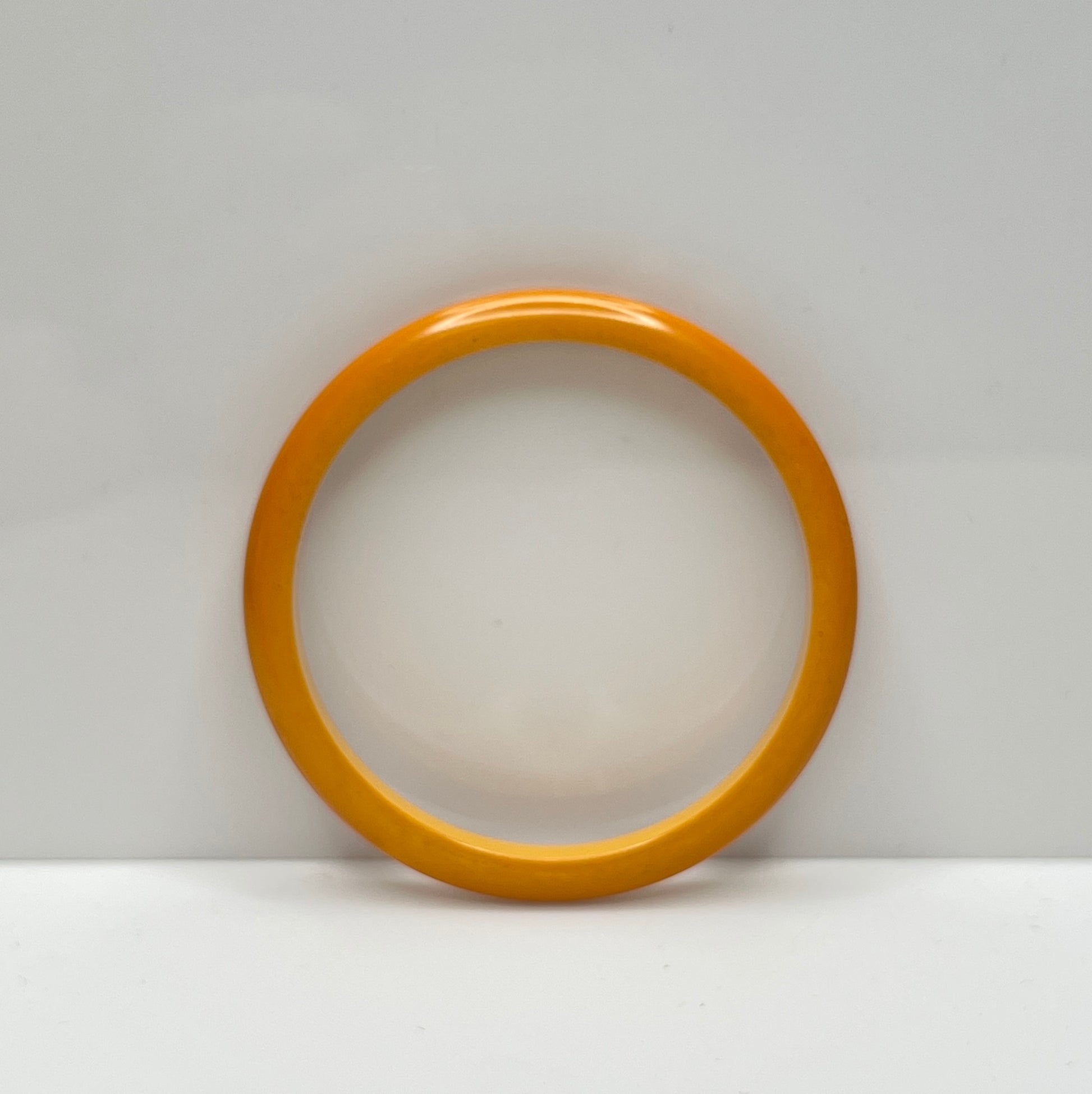 Smooth round Bakelite bangle in warm butterscotch color, size 8 fit