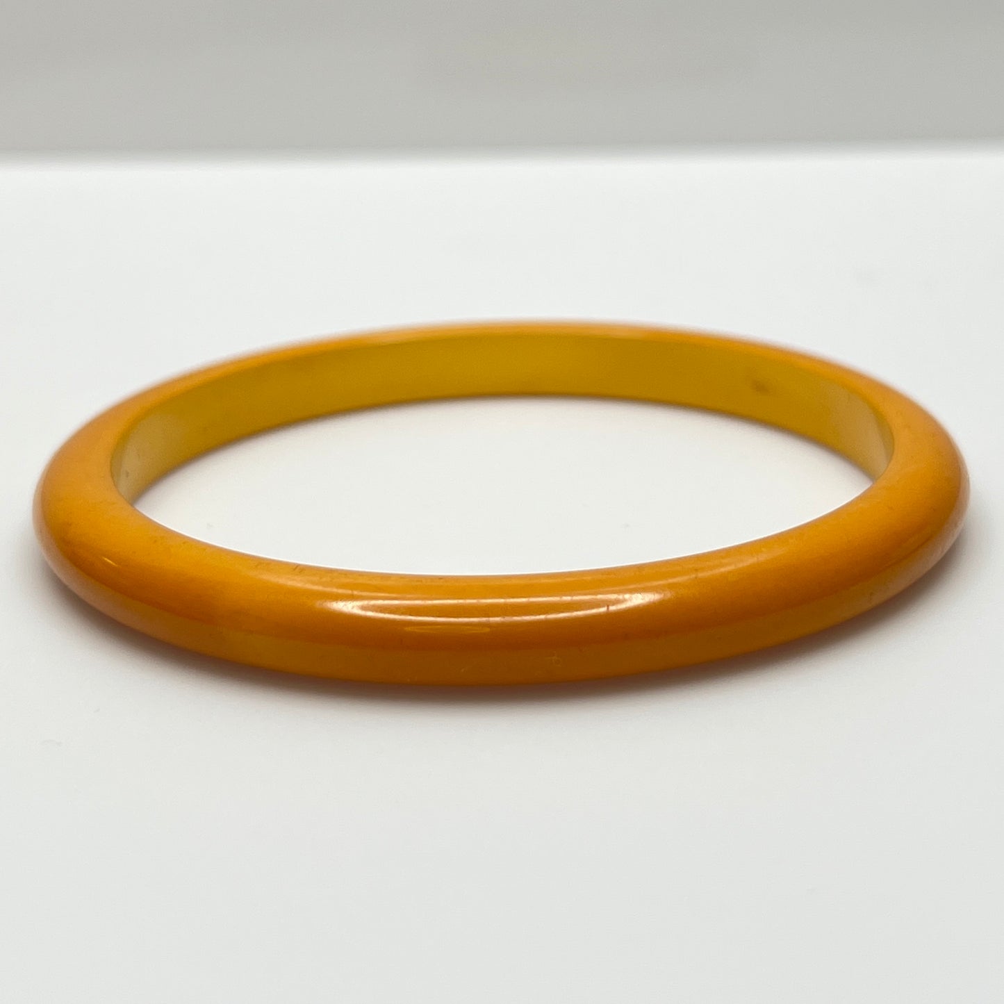 Close-up of vintage yellow Bakelite bracelet, 1/4 inch wide