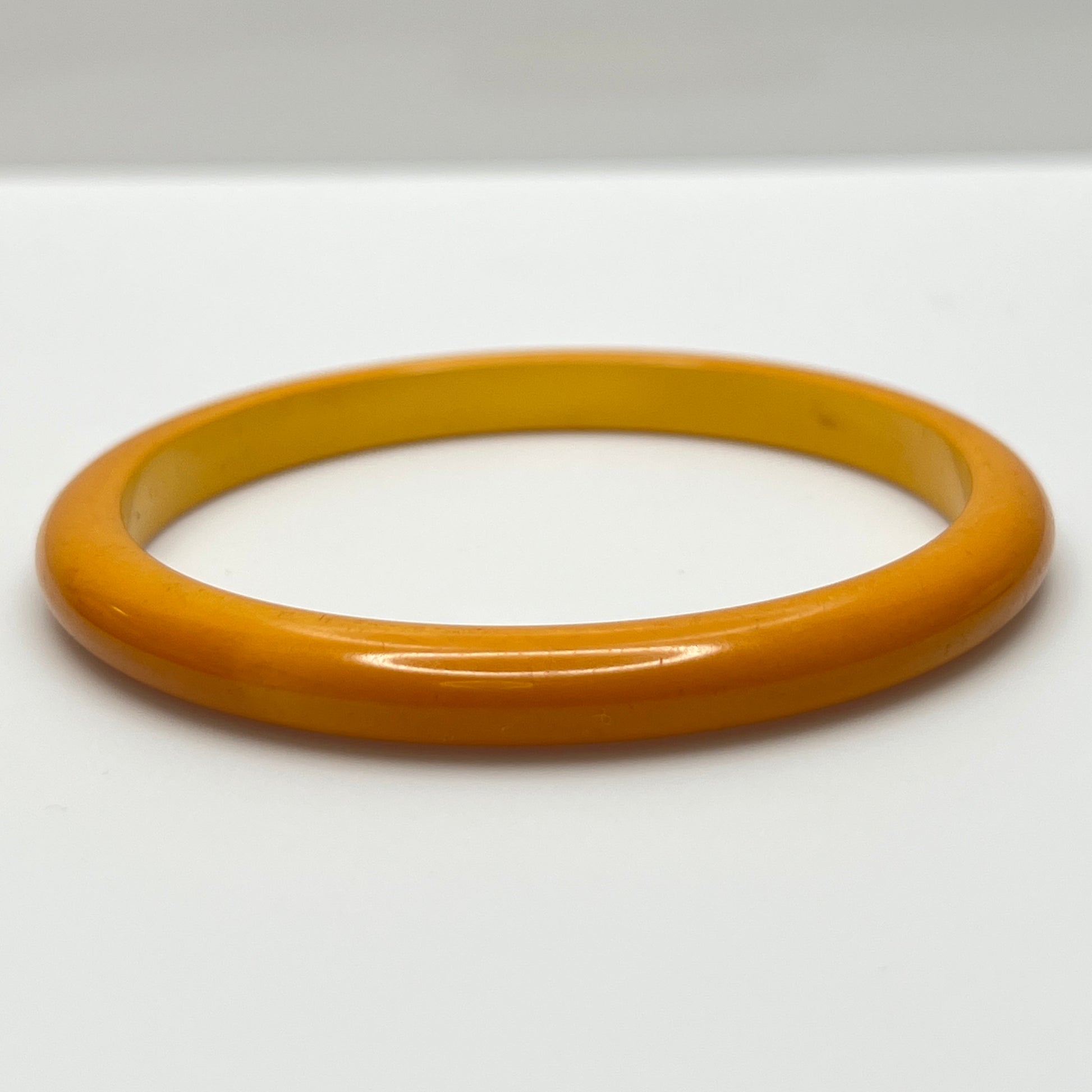 Close-up of vintage yellow Bakelite bracelet, 1/4 inch wide
