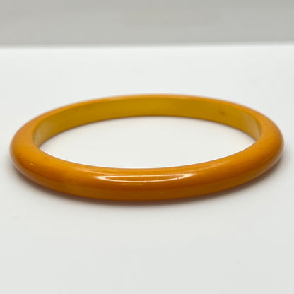 Close-up of vintage yellow Bakelite bracelet, 1/4 inch wide