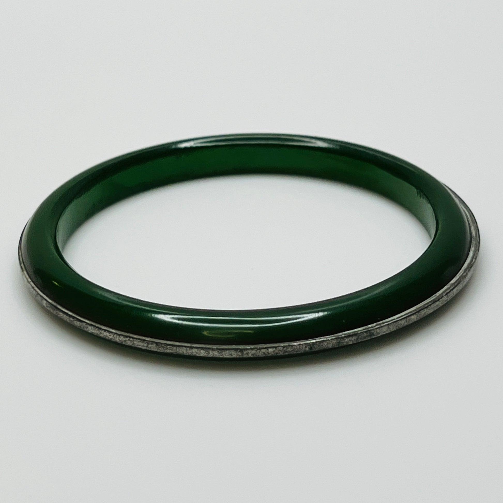 Close-up of green Bakelite with aged metal inlay