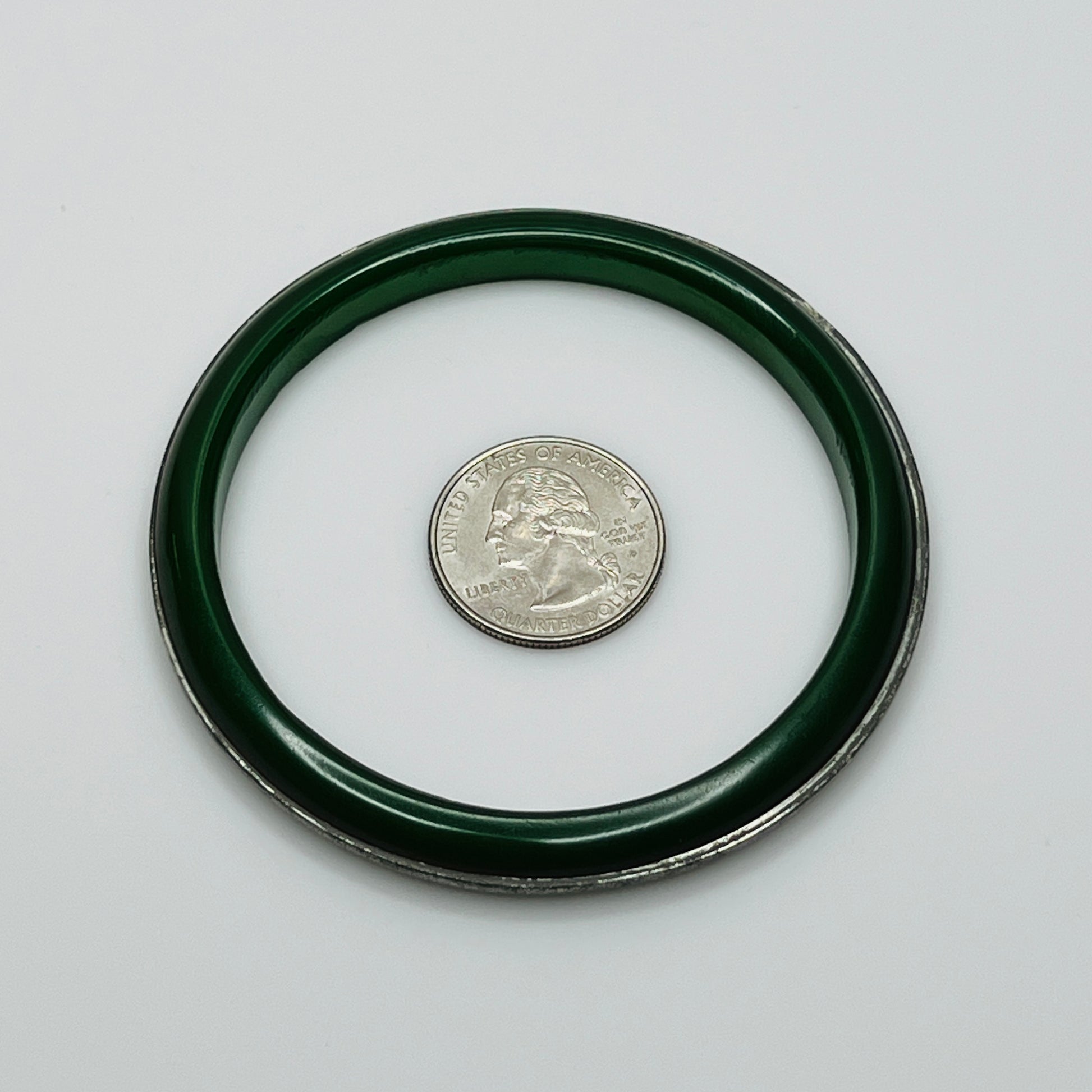 Round Bakelite bangle with inset silver-tone detail, flat lay