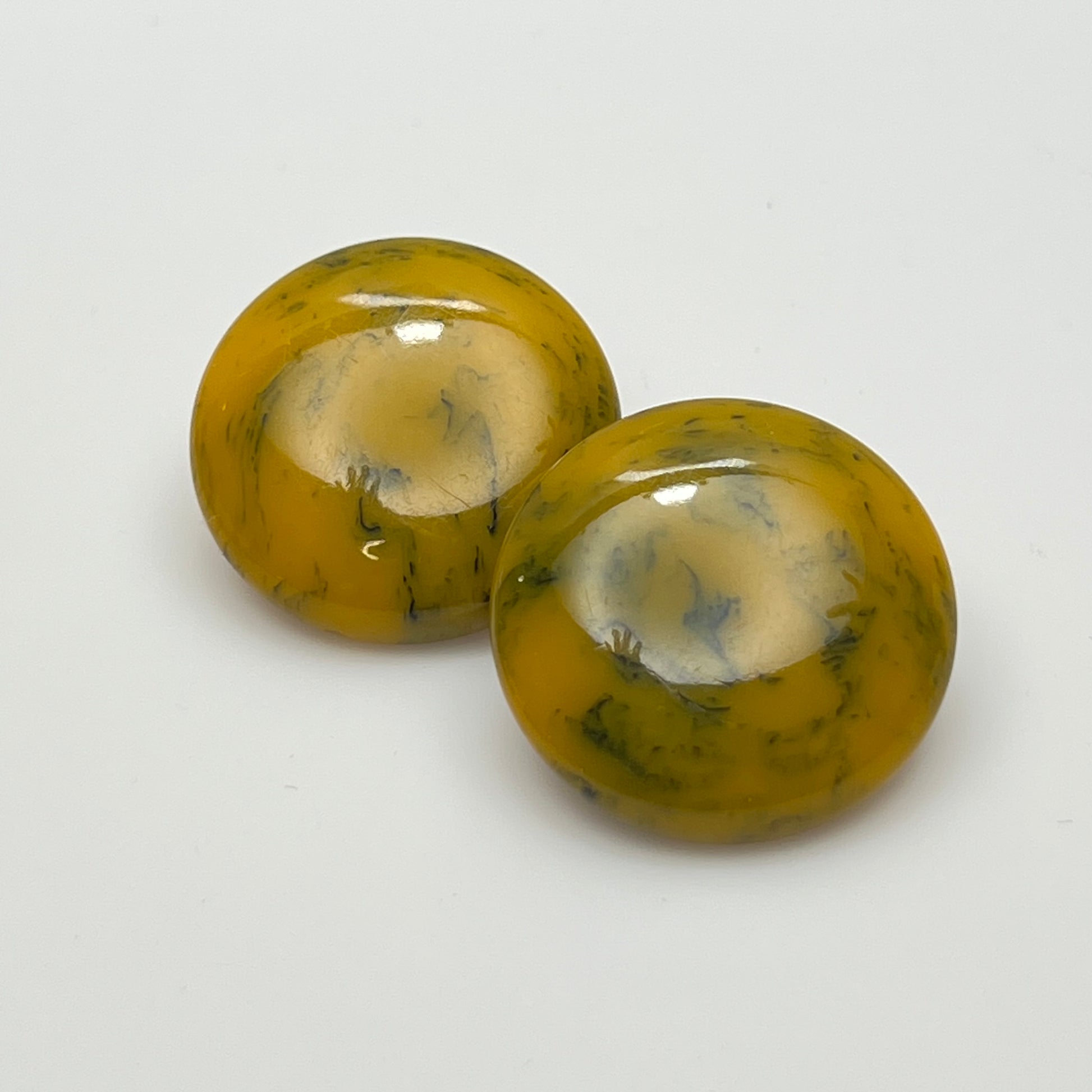 Pair of round marbled yellow and black Bakelite clip-on earrings