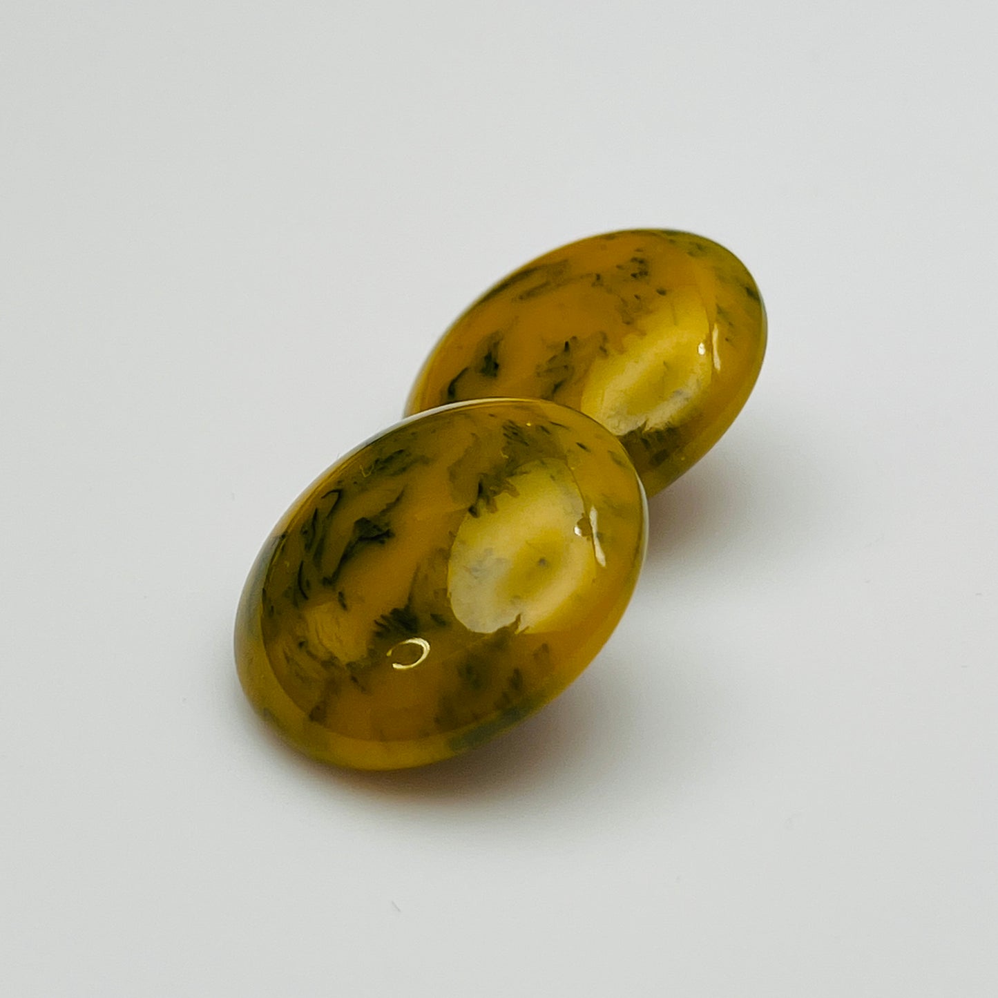 Pair of round marbled yellow and black Bakelite clip-on earrings