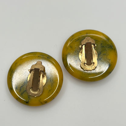Pair of round marbled yellow and black Bakelite clip-on earrings