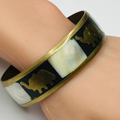 Brass elephant bangle worn on wrist, showcasing size and shine